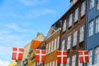 Copenhagen, Denmark. Nyhavn area, colorful painted houses, Denmark flag. Art Print